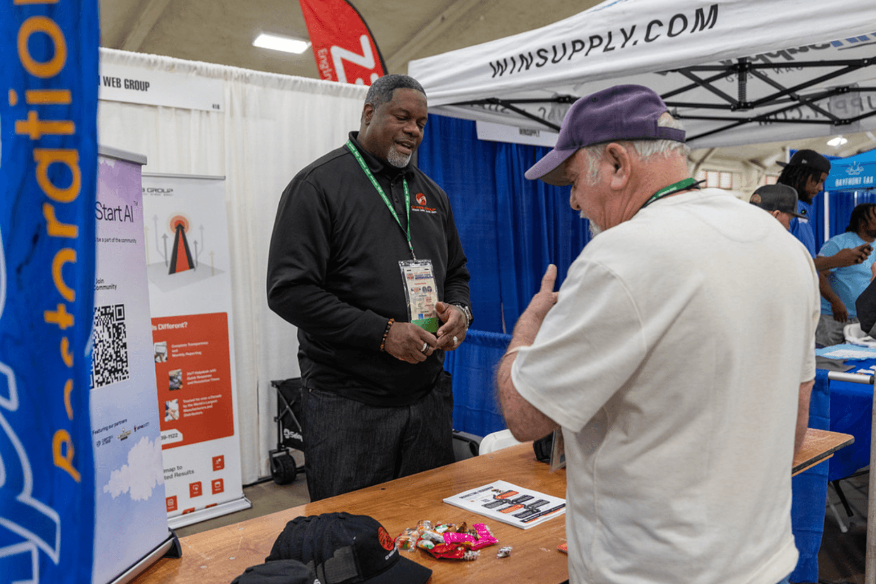 Business services exhibitor meeting with attendees at the Trades Expo