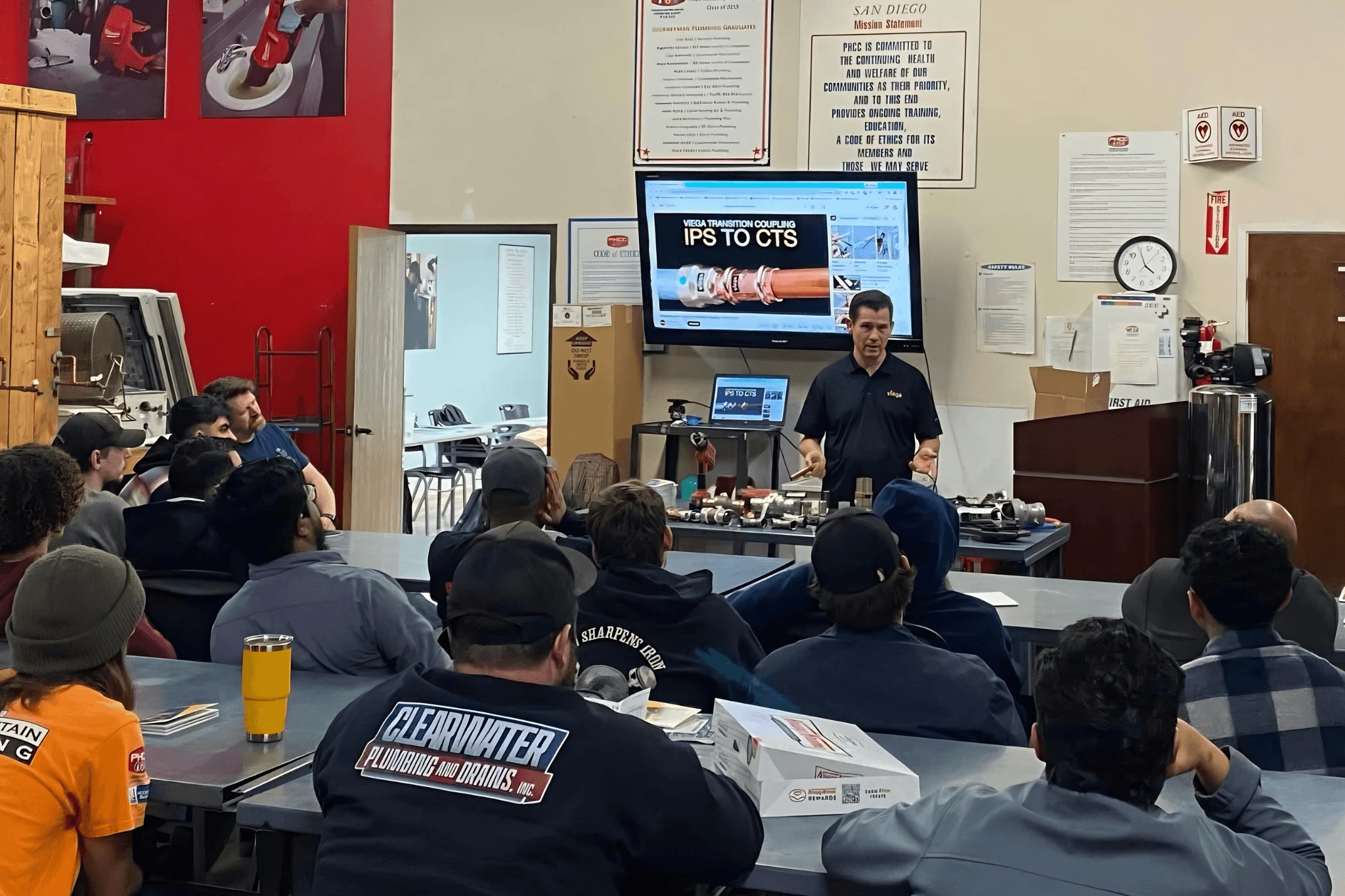 PHCC Academy instructor demonstrating plumbing tools and products during a San Diego training session