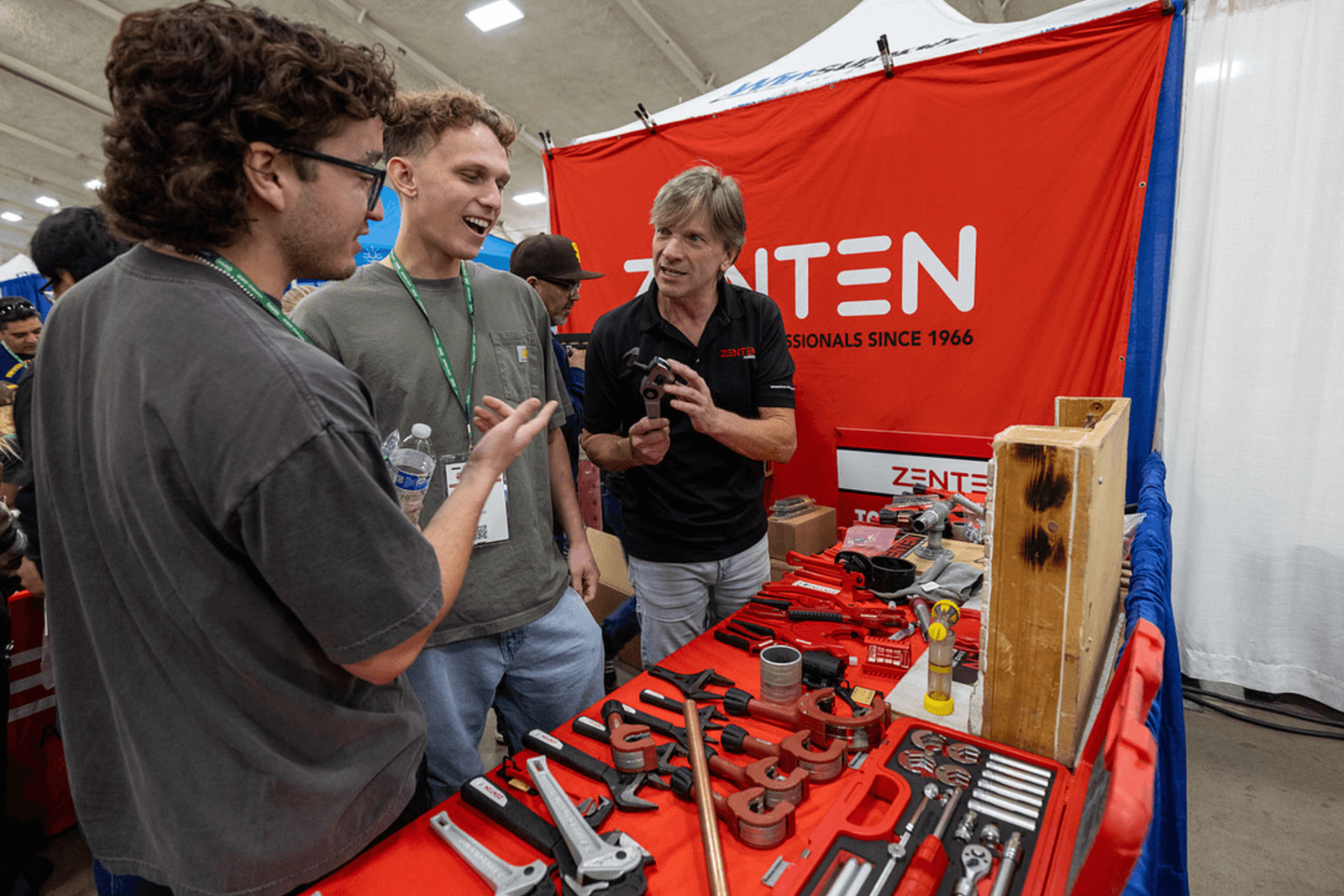 Exhibitor demonstrating a plumbing tool at the Trades Expo