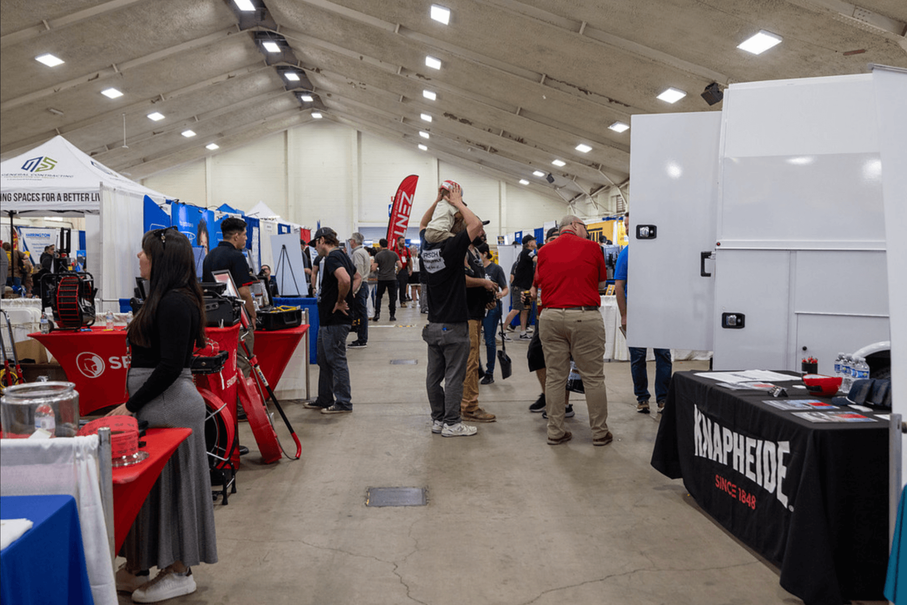 Wide view of attendees exploring exhibitor booths inside the PHCC San Diego plumbing and HVAC Trades Expo.